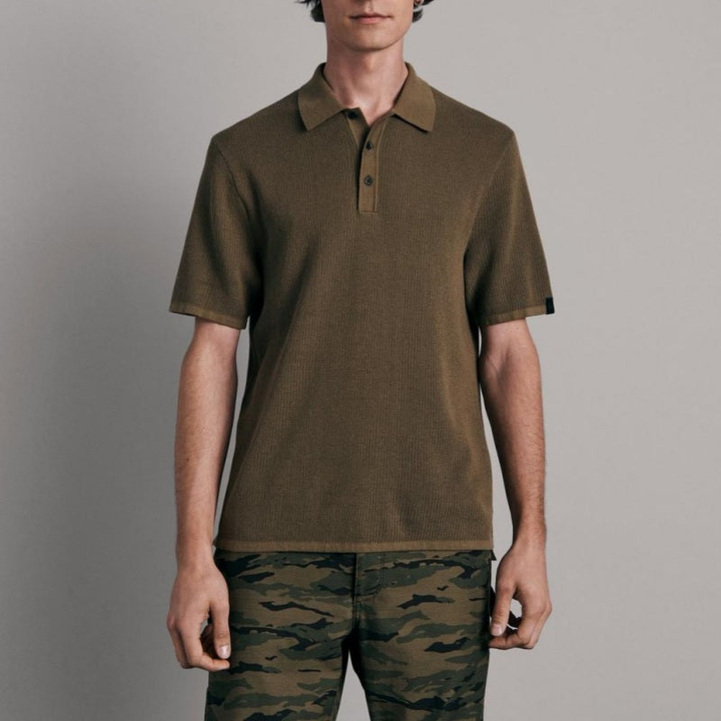 Model wearing Custom Short Sleeve Polo Collar Men's Plain Knitwear in olive green, front view.
