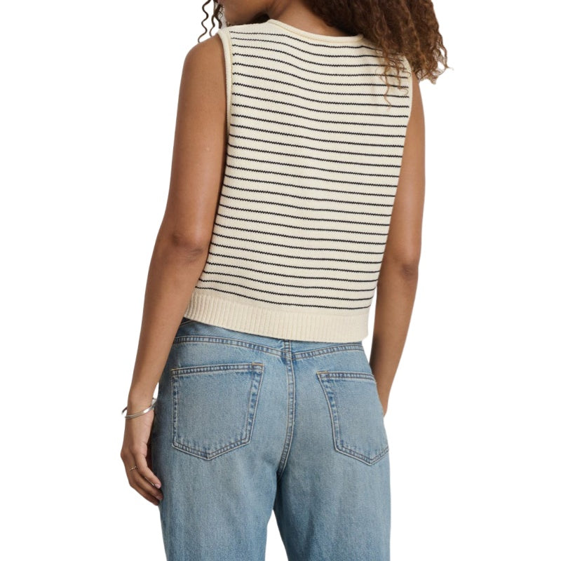 Back view of a woman wearing a custom stripe knit vest with black and cream horizontal stripes, showing its relaxed fit.