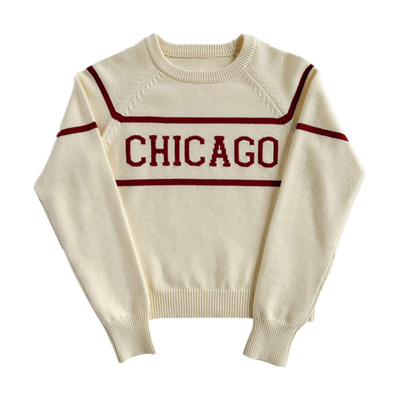 White knit pullover sweater with red horizontal stripes and the word 'CHICAGO' in red across the chest.