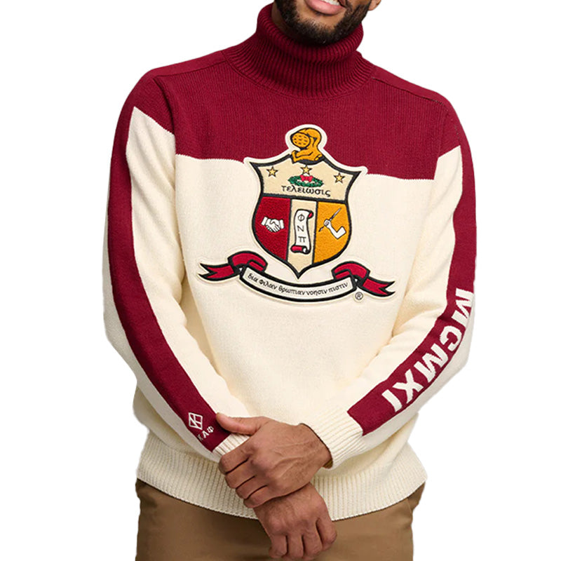 Man posing in a custom fraternity sweater featuring a red top and cream bottom, with 'Kappa Alpha Psi' logo embroidered displayed on the front and 'MCIMXI' on the sleeve.