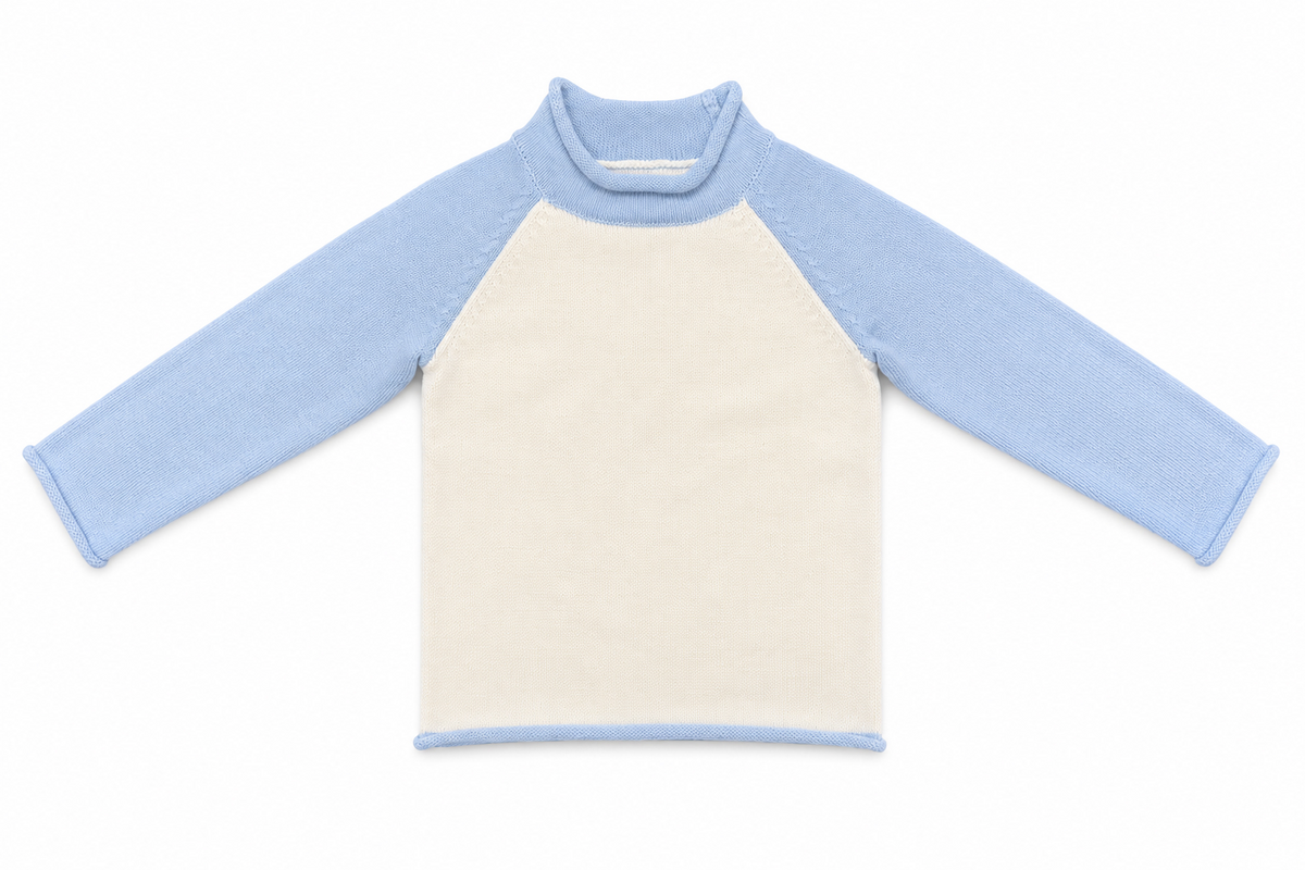 Kids' ivory knit pullover with light blue raglan sleeves, front view.