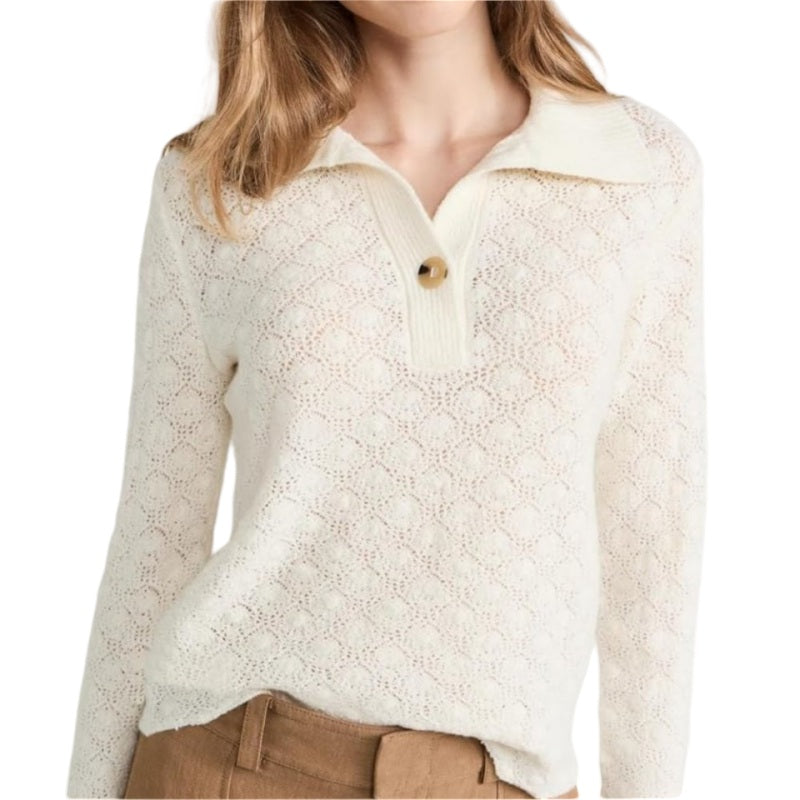 Woman wearing a custom knitted linen polo sweater in ivory, featuring delicate lace patterns and a single button collar.