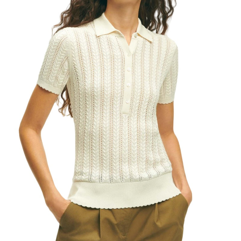 Woman wearing a custom cream linen knit polo sweater with vertical lace patterns and a three-button placket.