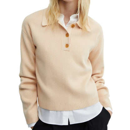 Woman wearing a custom beige wool-cotton knit polo sweater, styled over a white collared shirt.