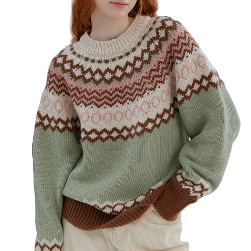 Woman wearing a cashmere blend crew neck sweater with paisley pattern in shades of green and brown
