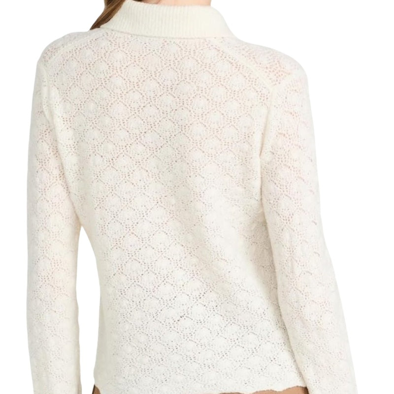 Back view of a woman wearing a custom knitted linen polo sweater in ivory with intricate lace patterns.