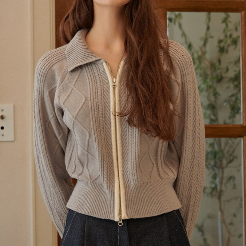 Front view of a woman wearing a custom cashmere zipper sweater with elegant cable-knit patterns and a full front zipper.