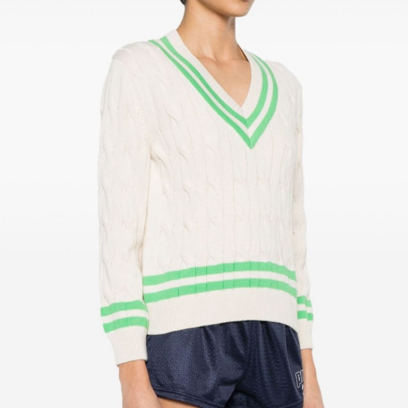 Model wearing a custom 100% cotton V-neck sweater in off-white with green stripes, styled casually.