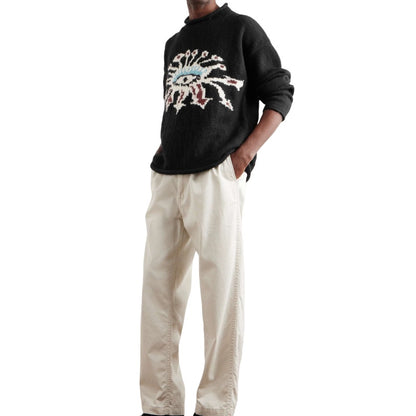 Full-length view of a man wearing a custom-designed merino wool crew neck sweater, perfect for wholesale.