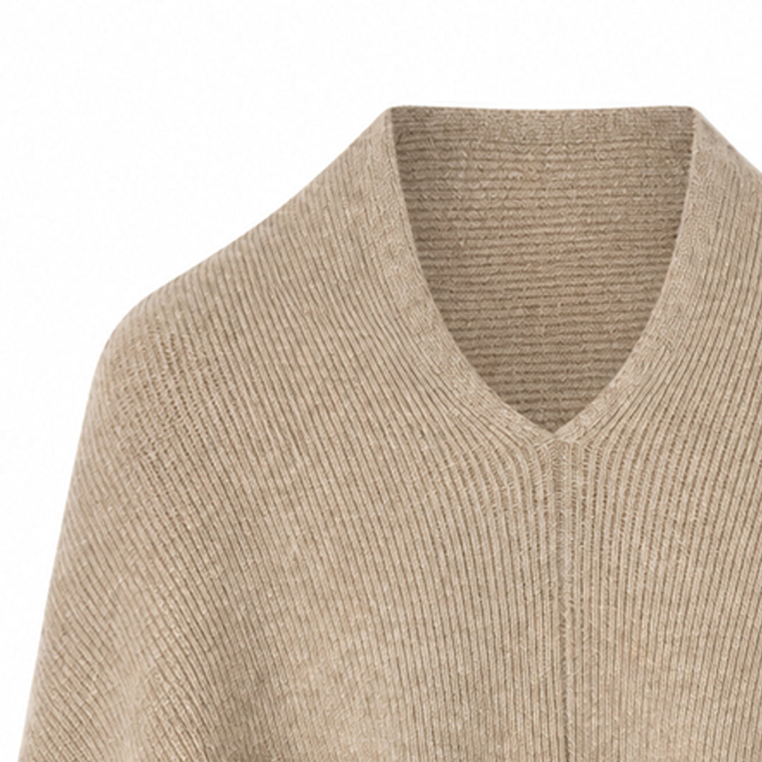 Close-up of the V-neck and fine knit texture on a women's poncho sweater