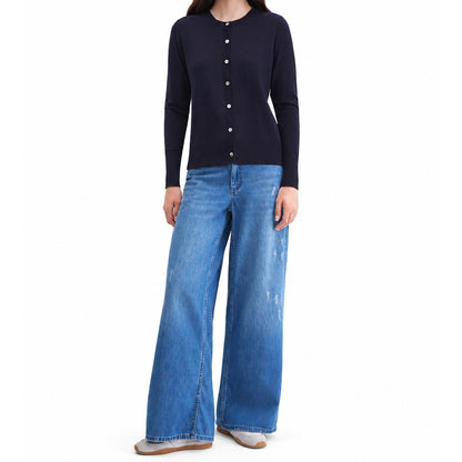 Women's black knit cardigan styled with wide-leg blue jeans, front view.