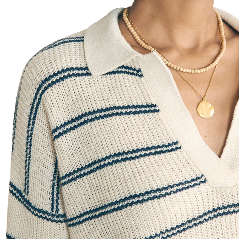 Close-up front view of a custom wholesale cotton blend striped V-neck pullover sweater in beige with a gold necklace