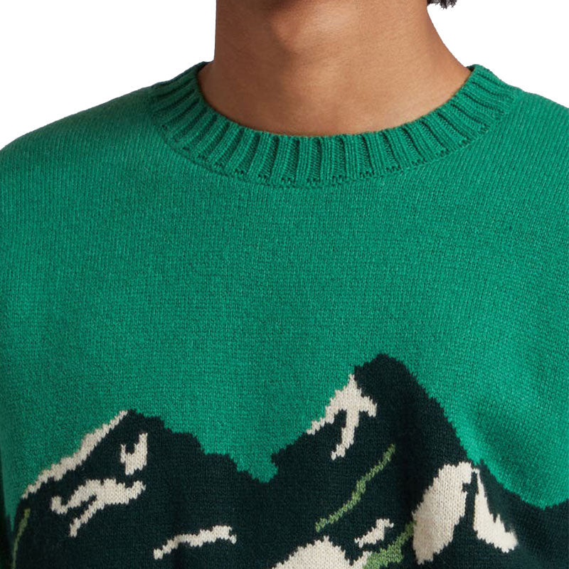 Close-up of the mountain jacquard pattern on a green wool blend pullover knit sweater.