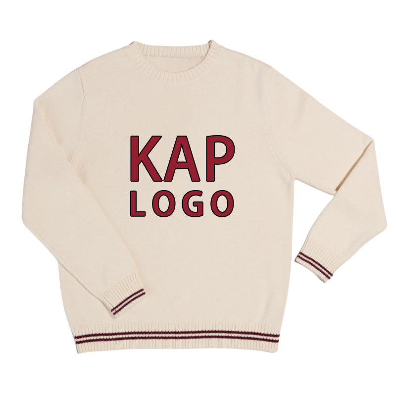 Custom Greek sweater in cream with maroon text 'KAP LOGO', laid flat.