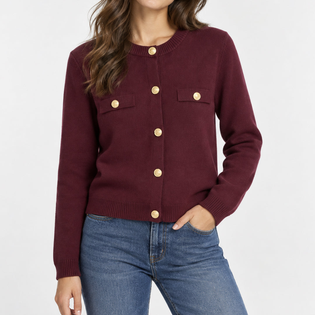 Woman wearing a burgundy knit cardigan with contrast trim and gold-tone buttons