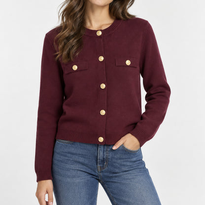 Woman wearing a burgundy knit cardigan with contrast trim and gold-tone buttons