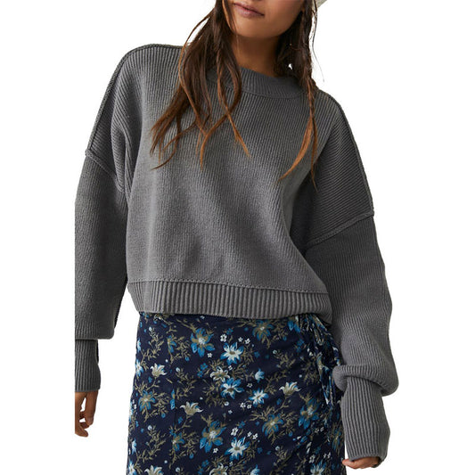 Woman wearing a custom wholesale cotton blend solid crew neck knit pullover sweater in grey with a floral skirt