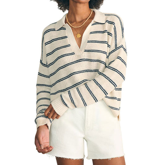 Woman wearing a custom wholesale cotton blend striped V-neck pullover sweater in beige and white shorts