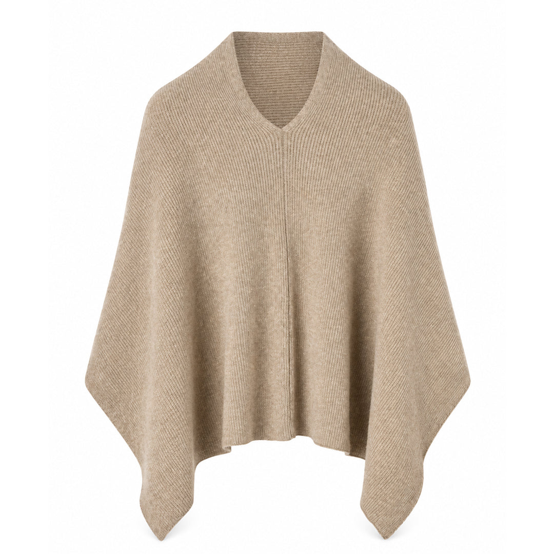 Model wearing a loose-fit women's poncho pullover with a draped silhouette