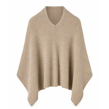 Model wearing a loose-fit women's poncho pullover with a draped silhouette