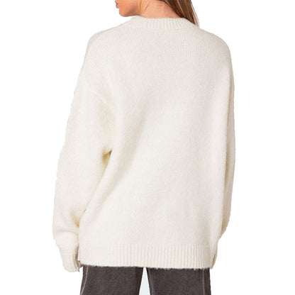 Back view of a woman in a white knit sweater showcasing the solid back design and cozy fit.