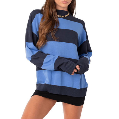 Woman wearing a blue and navy striped oversized cotton knit pullover.