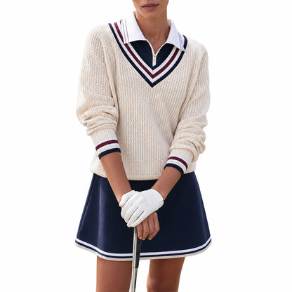 Woman wearing a cream varsity V-neck sweater with navy and burgundy stripes