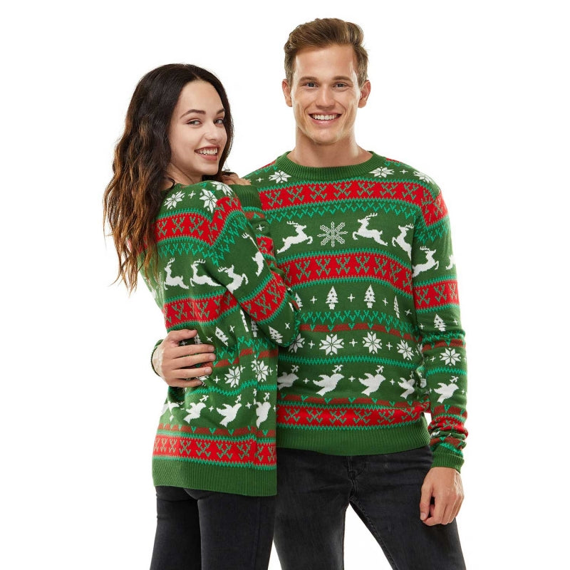 Couple wearing matching custom 100% cotton sweaters with a festive Fair Isle design in green, red, and white colors. The sweaters feature holiday motifs including reindeer, snowflakes, and Christmas trees, perfect for couples looking to match in festive attire.