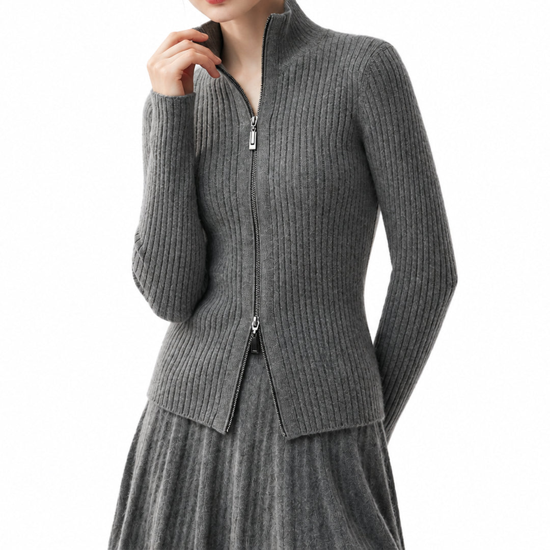 Woman wearing a charcoal grey zip-up knit cardigan with a stand collar.