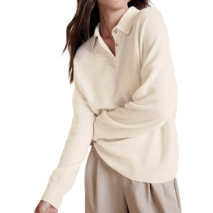 Woman wearing a beige cashmere blend knit sweater with a polo collar, paired with beige trousers.