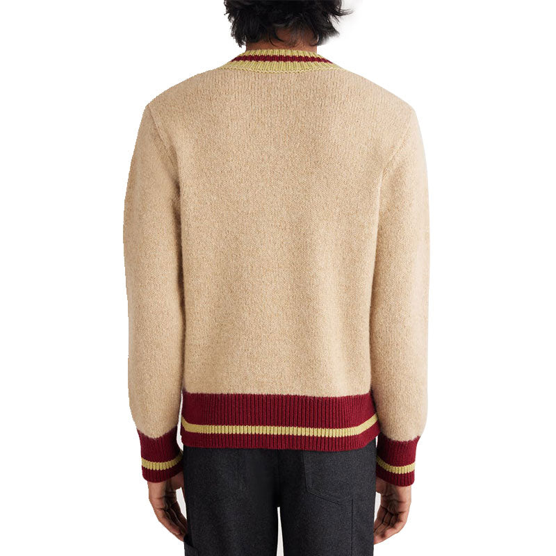 Custom striped knit sweater in beige with red and yellow accents, worn by a model, back view.