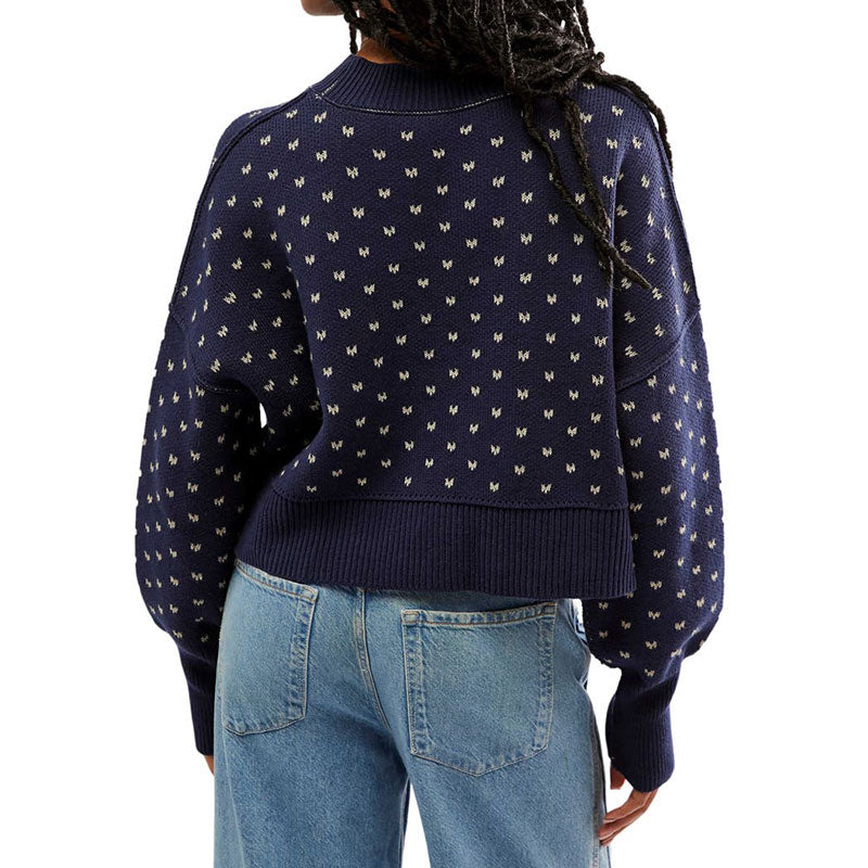 Back view of a custom navy blue knit sweater with a small butterfly pattern, highlighting the relaxed, cropped fit and ribbed detailing.