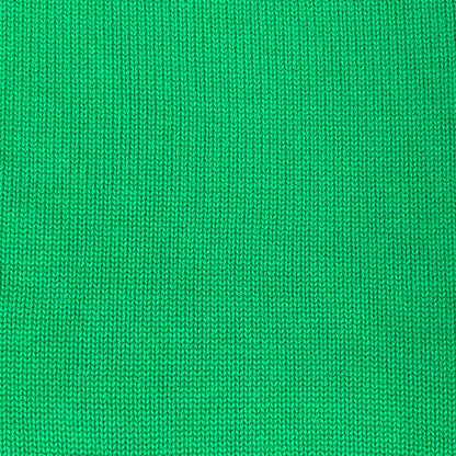 Close-up of fine gauge knit fabric in green – high-quality texture for custom Greek cardigans.