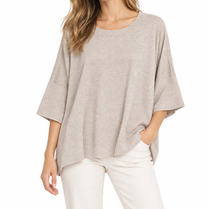 Model wearing a relaxed-fit women's short-sleeve knit pullover