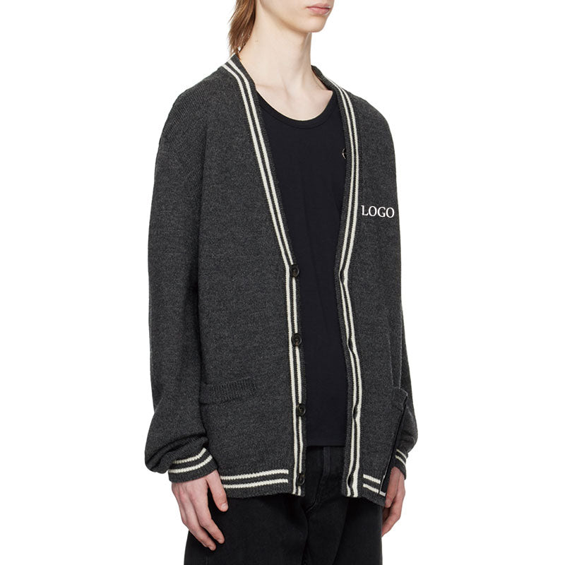 Side view of custom solid cotton blend knit cardigan with letter detail and V-neck