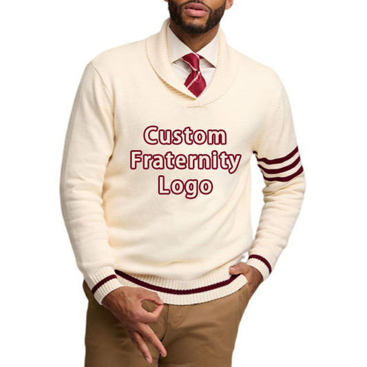 A man wearing a cream-colored custom fraternity sweater with maroon stripes on the sleeves and the text 'Custom Fraternity Logo' on the front, paired with a red tie.