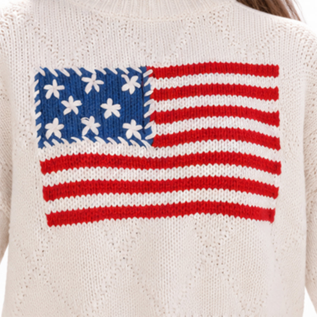 Close-up of American flag graphic on cream knit sweater