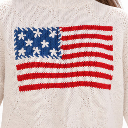 Close-up of American flag graphic on cream knit sweater