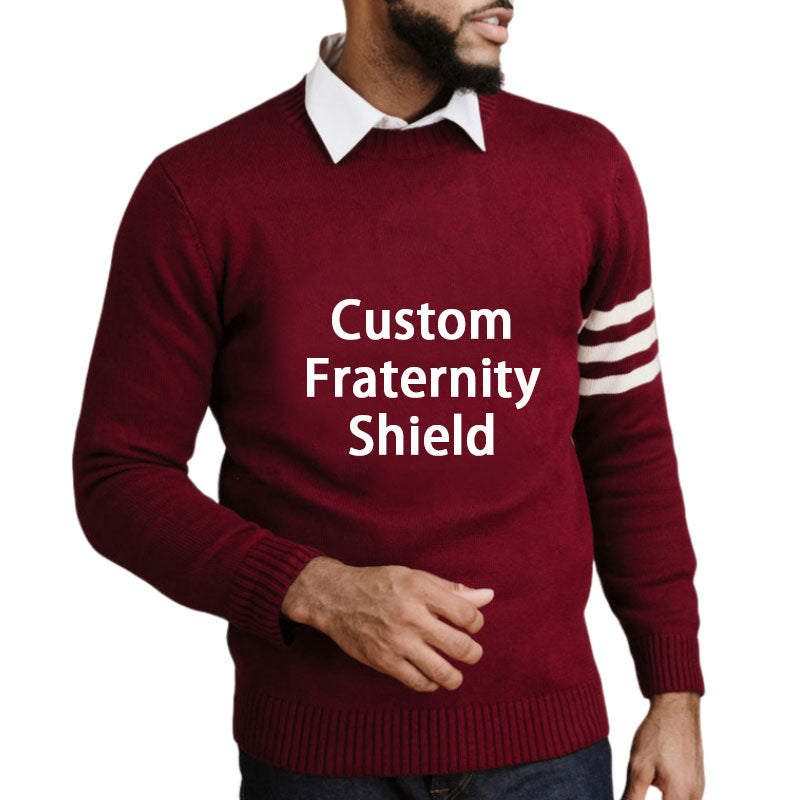 Custom maroon fraternity sweater with embroidered shield and two white stripes on the sleeve. Bulk manufacturing available for Greek organizations