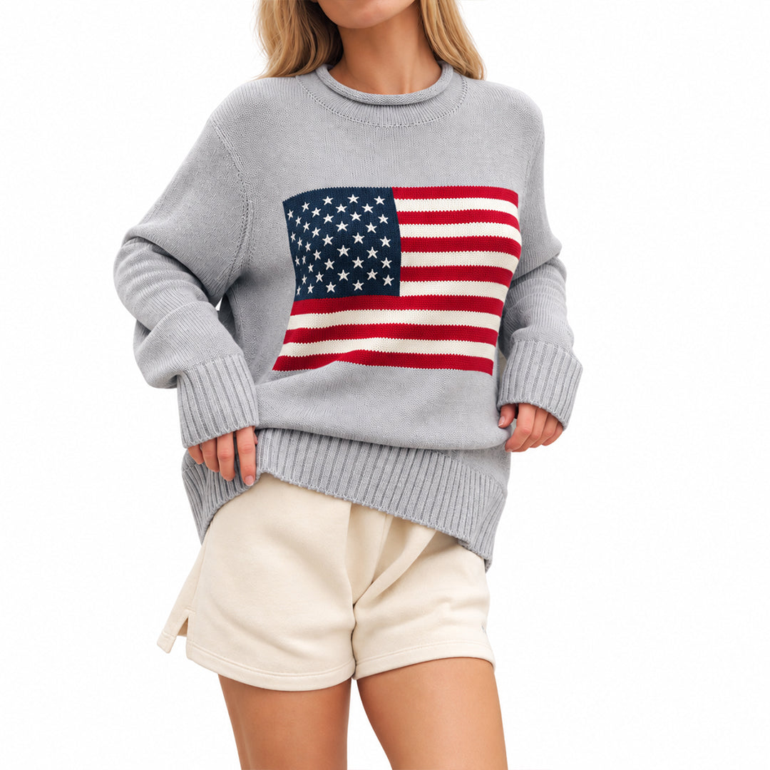 Model wearing a relaxed grey American flag graphic sweater
