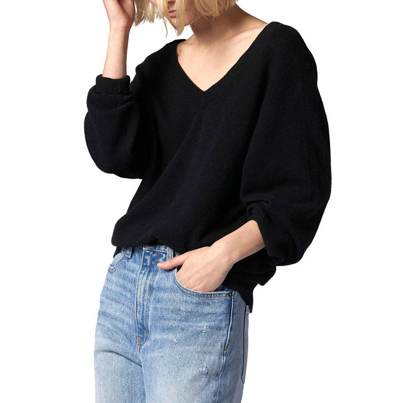 Side view of a black V-neck wool blend pullover sweater worn by a model, featuring loose sleeves and a relaxed fit.