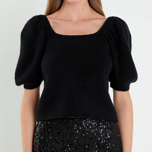 Front view of a woman wearing a custom 100% cotton puff sleeve square neck women's knitted sweater in black.
