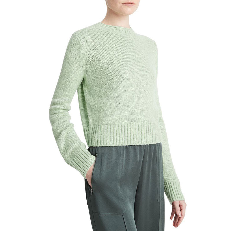 Side view of mint green cashmere blend pullover sweater with ribbed hem and cuffs.