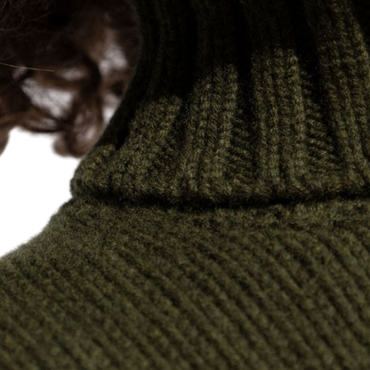 Close-up view of the ribbed neck detail on an olive green wool blend turtleneck sweater.