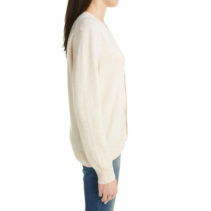 Side profile of a model in a beige V-neck cardigan sweater - custom design knitwear.