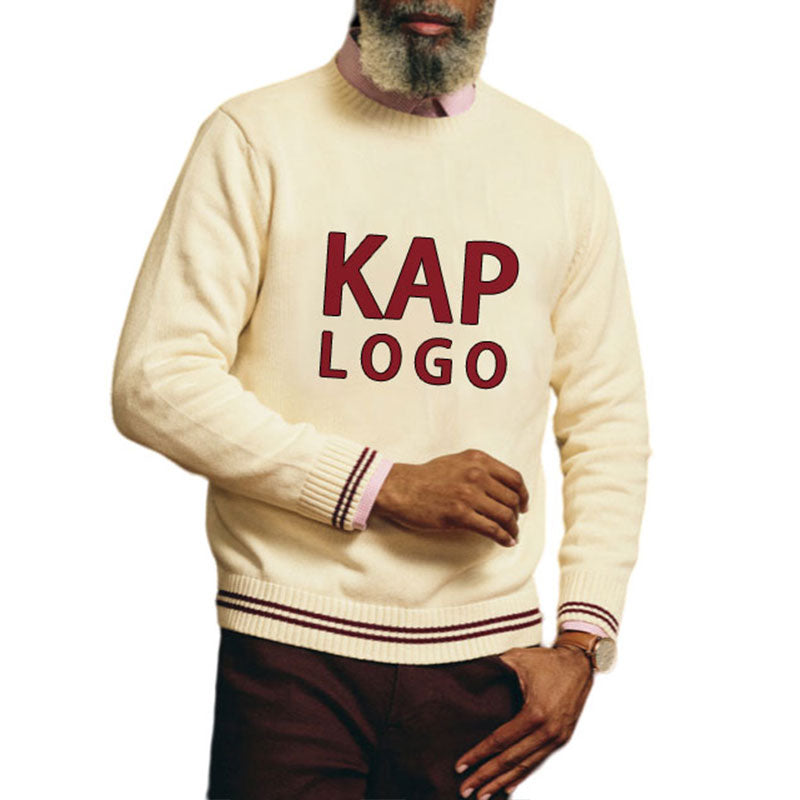 Man wearing a custom Greek embroidery sweater in cream with maroon text 'KAP LOGO'.