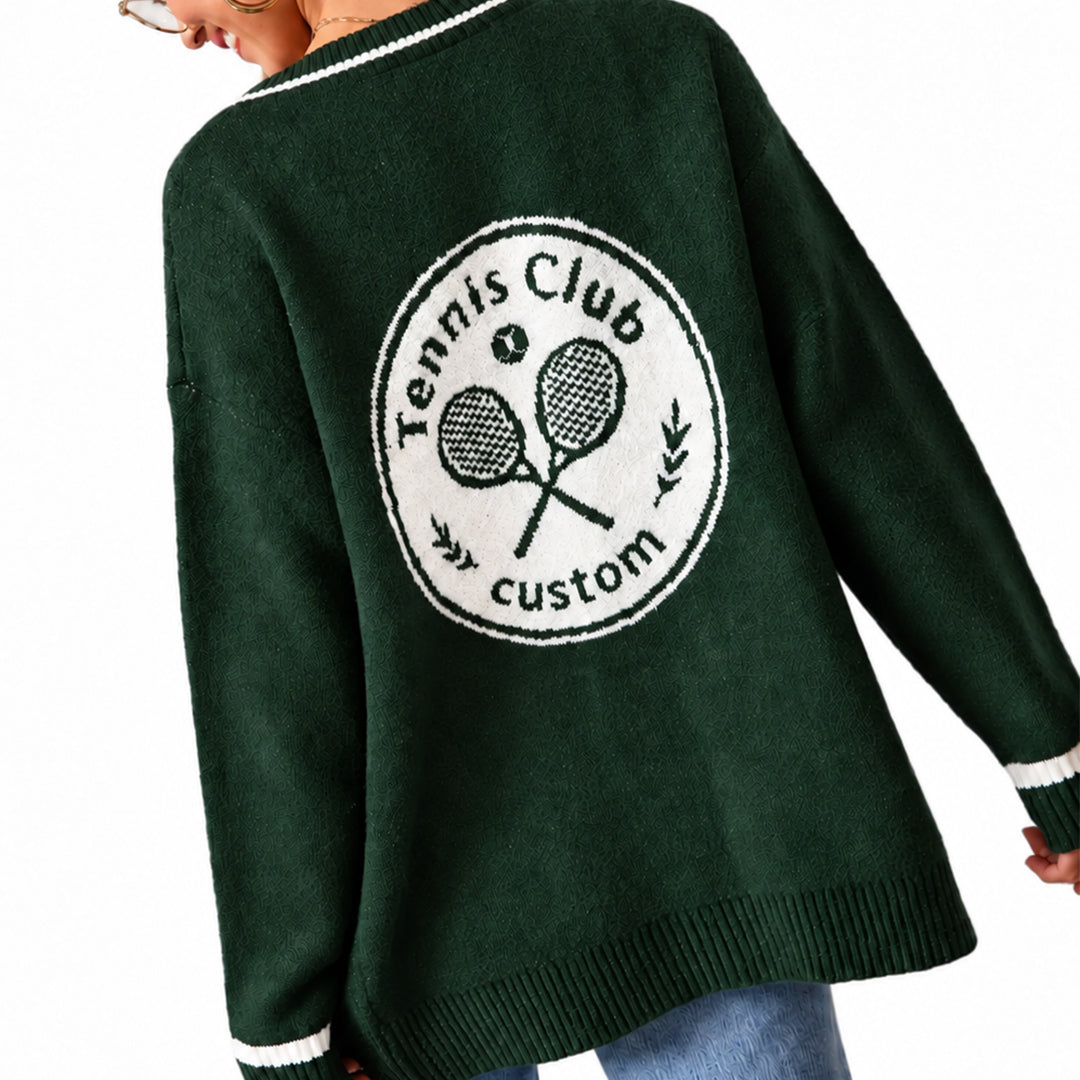 Close-up of a tennis club emblem and striped cuff on a green cardigan