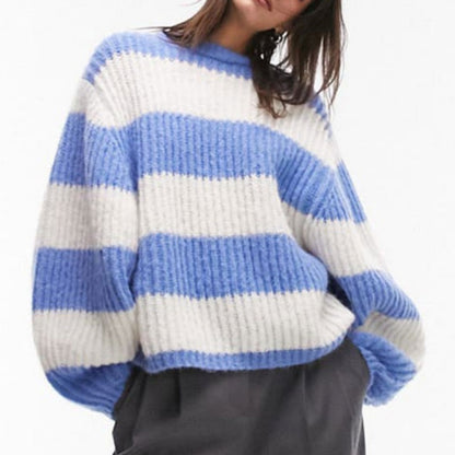 Woman wearing a custom wool blend ribbed knit sweater with blue and white horizontal stripes, featuring an oversized design.