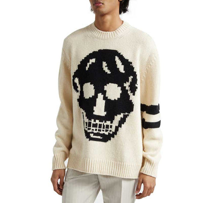 Side view of a custom wool blend knit sweater featuring a bold black skull pattern on the front and striped detailing on the sleeve, highlighting the relaxed fit and edgy design.