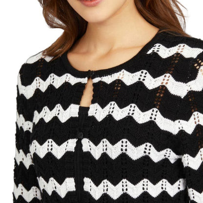 Close-up view of a custom black and white zigzag stripes knit cardigan, featuring intricate open-knit detailing and a round neckline.